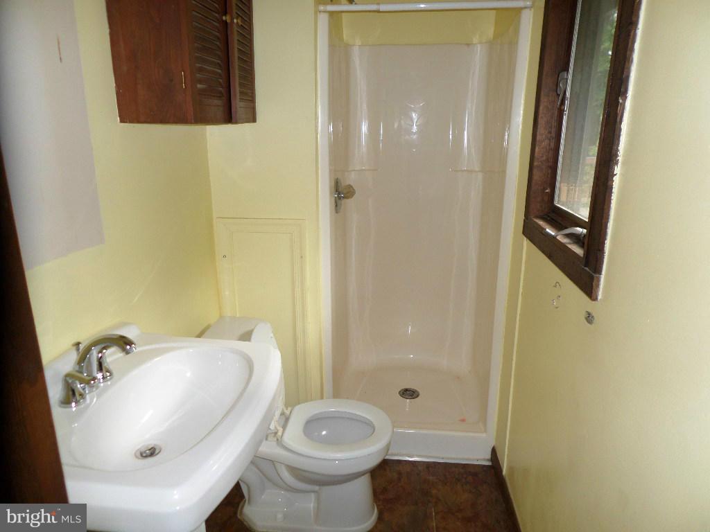 4242 Roop Road Mount Airy, MD 21771 - Photo 7 of 14 a bathroom with a sink toilet and shower