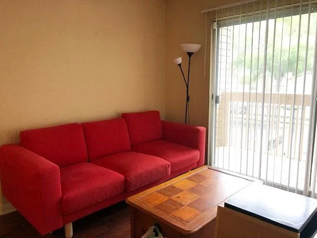 a living room with furniture and a window