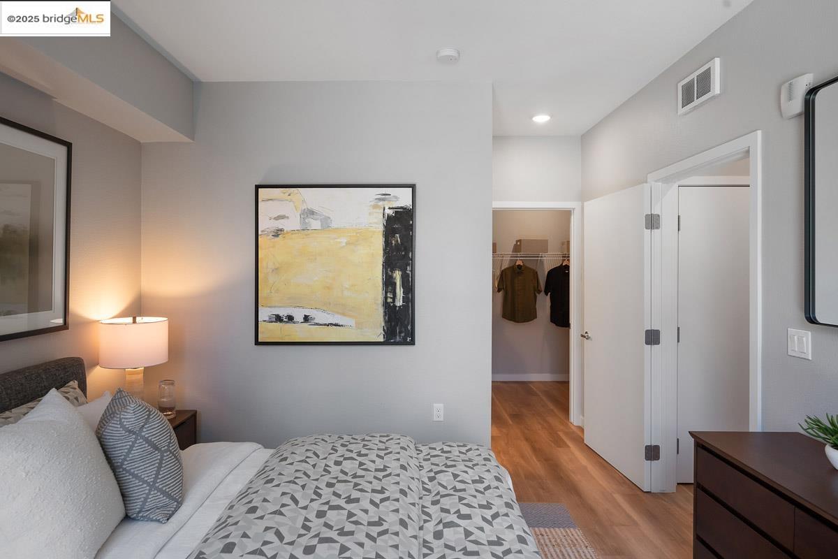 260 Brooklyn Basin Way, Unit 417 Oakland, CA 94606 - Photo 14 of 48 Bedroom featuring a spacious closet, light wood finished floors, and recessed lighting