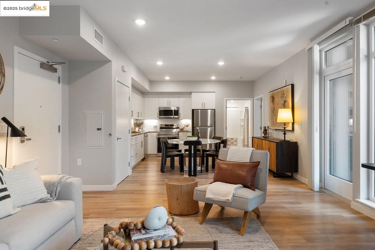 260 Brooklyn Basin Way, Unit 417 Oakland, CA 94606 - Photo 5 of 48 Living area featuring recessed lighting, light wood-style floors, and electric panel