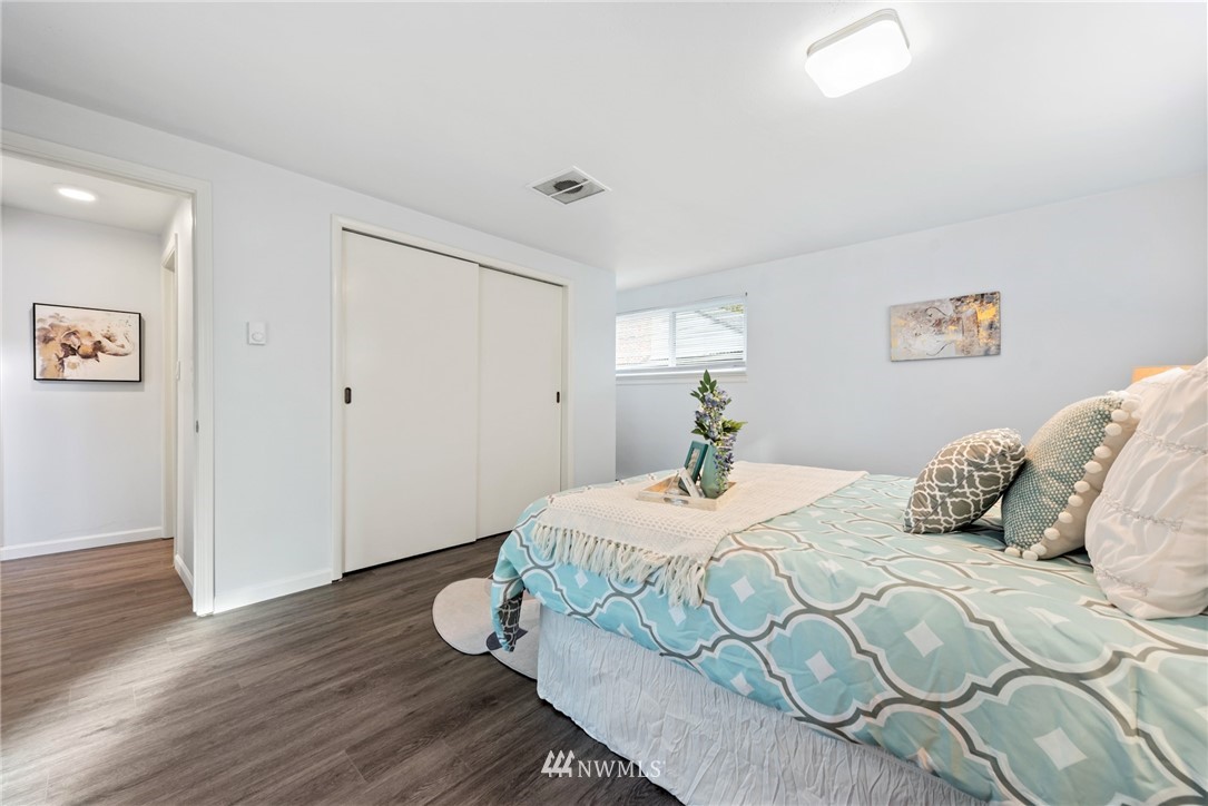 3309 Southeast 5th Street Renton, WA 98058 - Photo 11 of 23 a bedroom with a bed and wooden floor