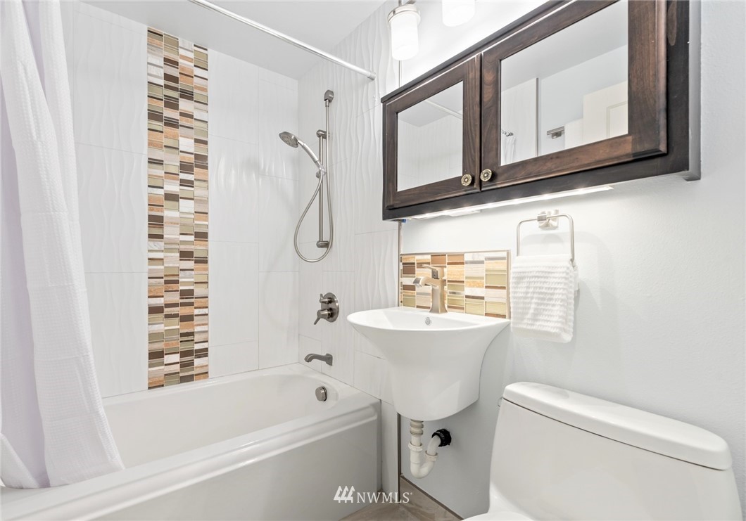 3309 Southeast 5th Street Renton, WA 98058 - Photo 12 of 23 a bathroom with a sink a toilet and a bathtub