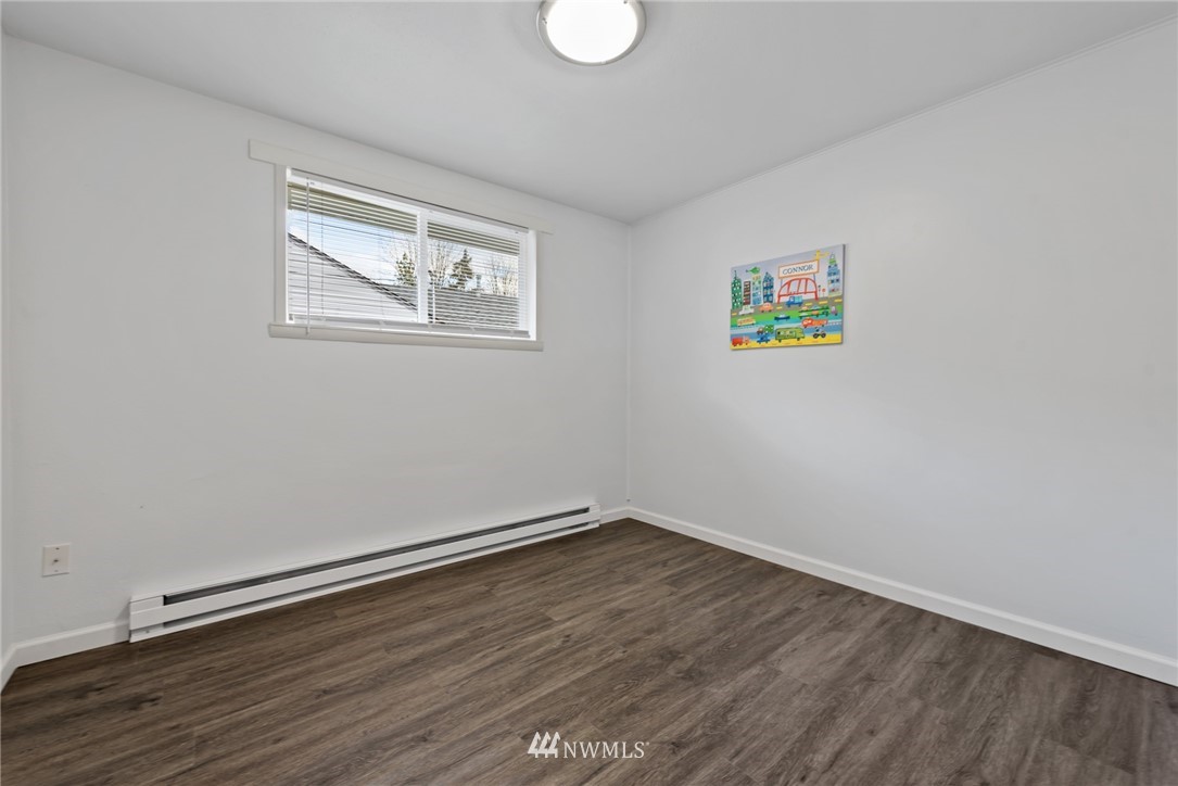 3309 Southeast 5th Street Renton, WA 98058 - Photo 18 of 23 a view of empty room with wooden floor and fan