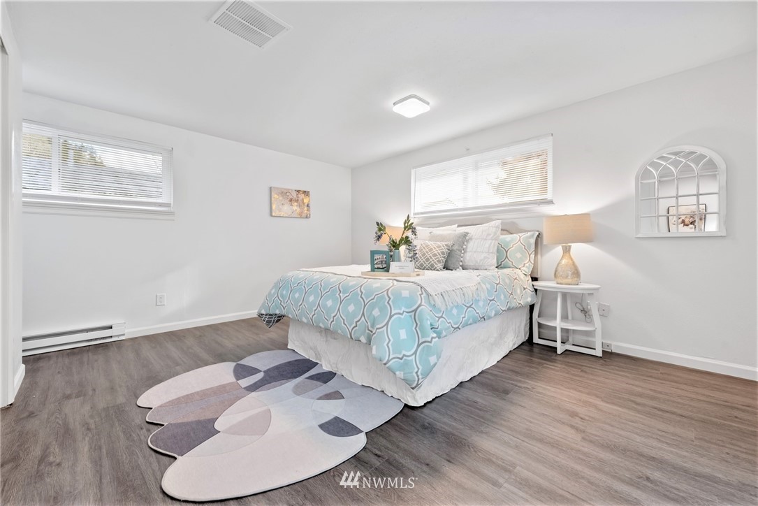 3309 Southeast 5th Street Renton, WA 98058 - Photo 9 of 23 a bedroom with bed and wooden floor