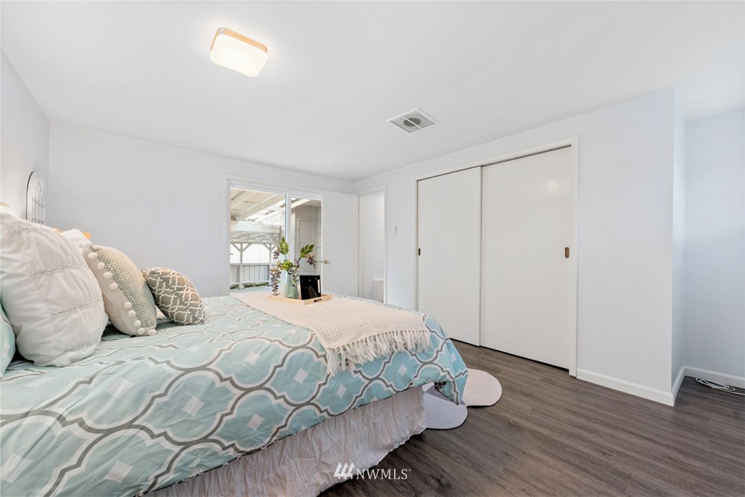 3309 Southeast 5th Street Renton, WA 98058 - Photo 10 of 23 a bedroom with a bed and wooden floor