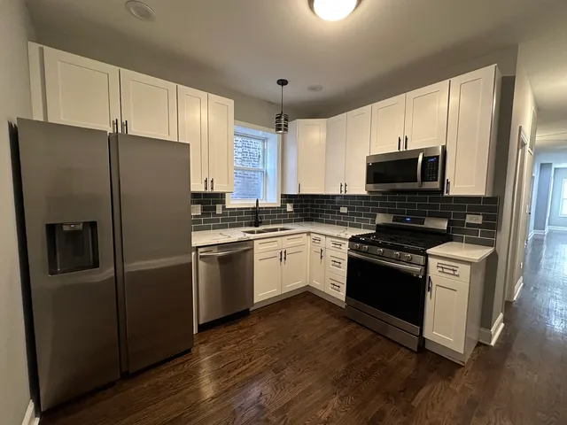 a kitchen with stainless steel appliances a refrigerator stove and microwave