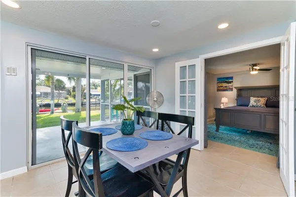 a living room with furniture and a floor to ceiling window