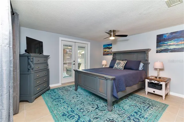a bathroom with a granite countertop sink a toilet and mirror
