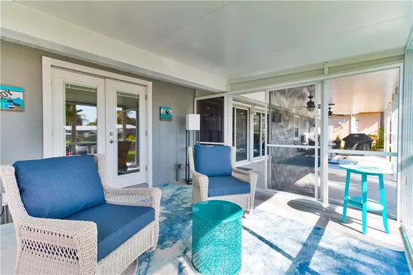 a view of a swimming pool with a yard and sitting area