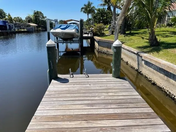 a view of a roof deck with table and chairs with wooden floor