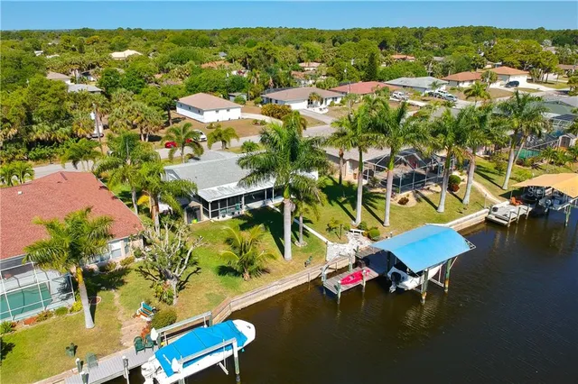 an aerial view of residential houses with outdoor space and swimming pool