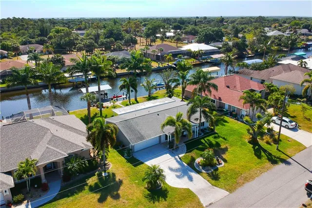an aerial view of residential houses with outdoor space and swimming pool