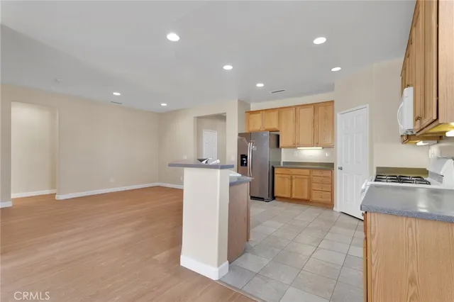 a kitchen with a refrigerator a stove top oven and a sink