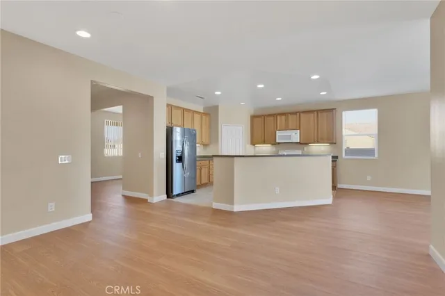 a view of a kitchen with a refrigerator and a window
