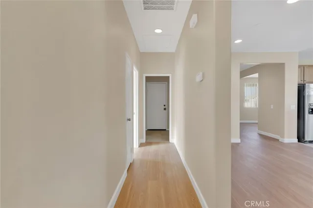 a view of a hallway with wooden floor
