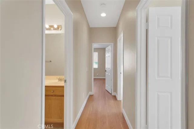 a view of a hallway with wooden floor