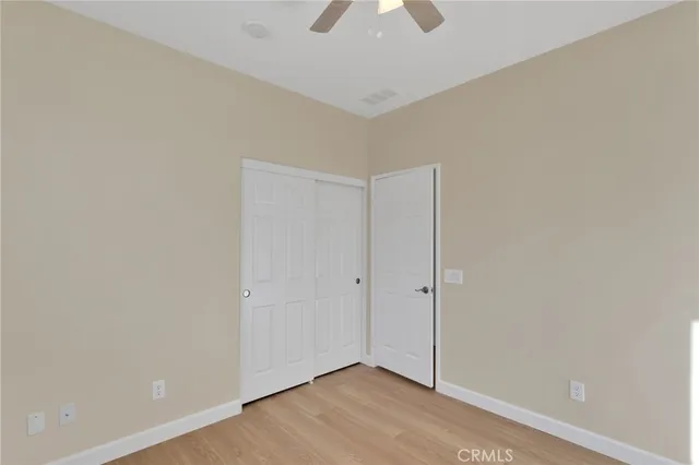 an empty room with a empty space and chandelier fan