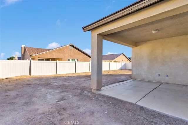 a view of a house with wooden fence