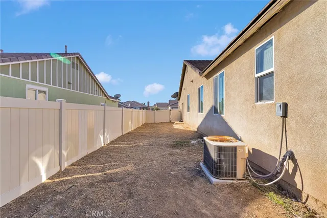 an aerial view of a house with a swimming pool and outdoor seating