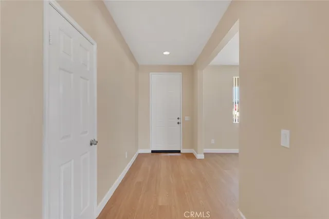a view of a hallway with wooden floor