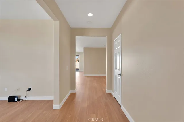 a view of a hallway with wooden floor