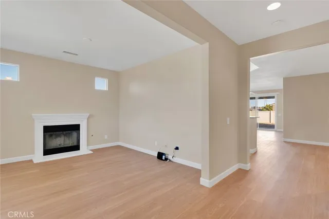 a view of empty room with a fireplace
