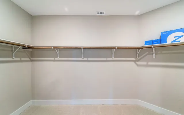 a bedroom with a bed and a mirror on dresser