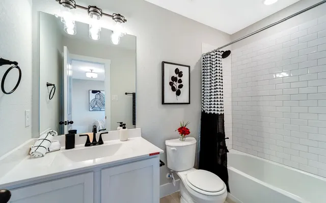 a living room with furniture a rug and a flat screen tv