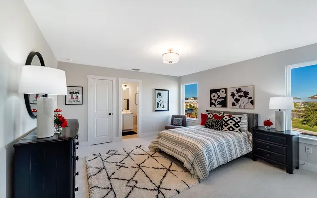 a living room with furniture a flat screen tv and a wall painting