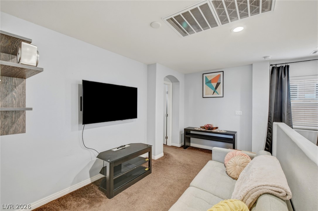 48 Jasmine Point Street Henderson, NV 89074 - Photo 34 of 62 A well-lit loft space features recessed lighting and inviting carpet flooring.
