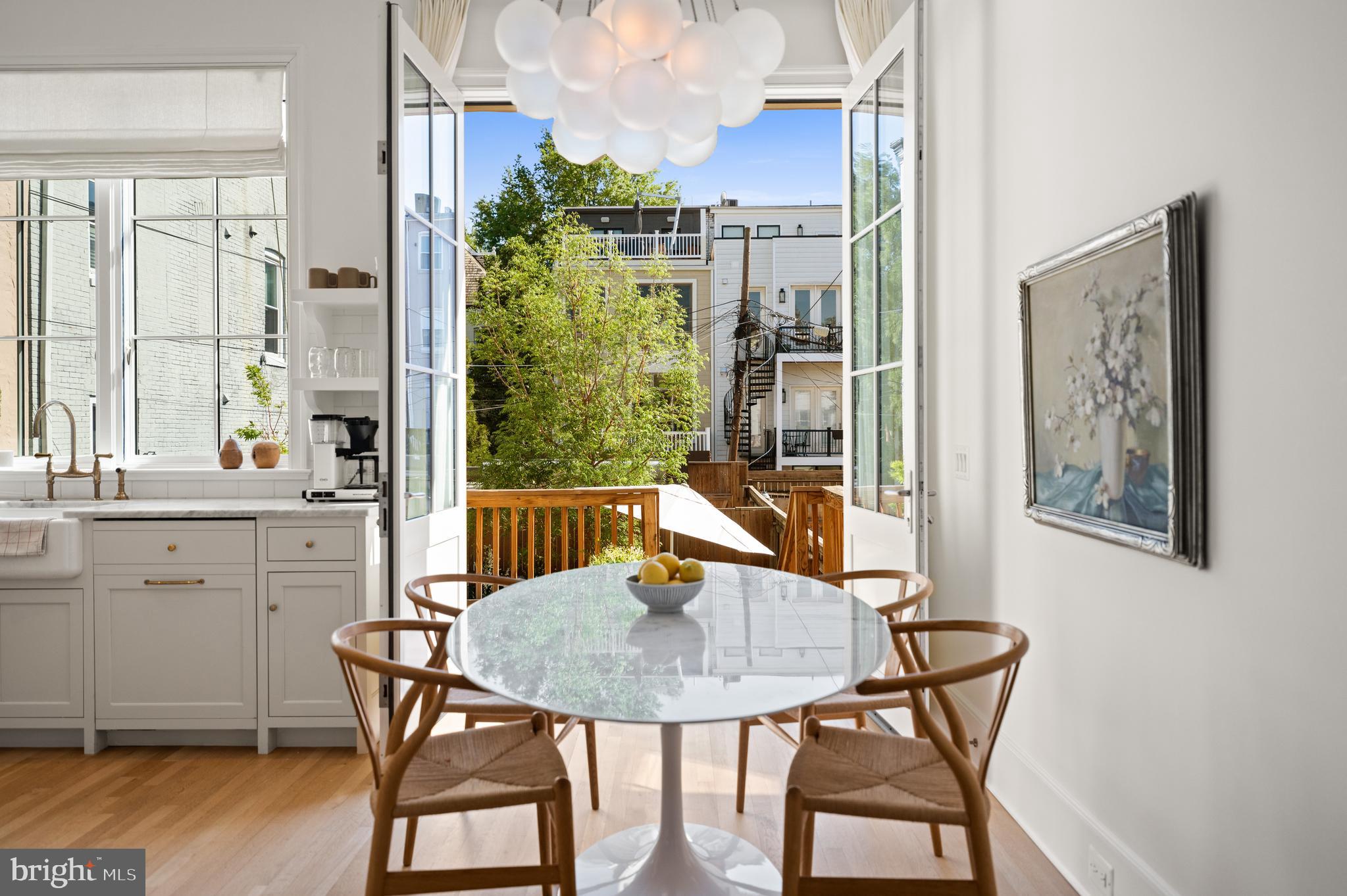 1304 S Street Northwest Washington, DC 20009 - Photo 4 of 23 a view of a dining room with furniture window and wooden floor
