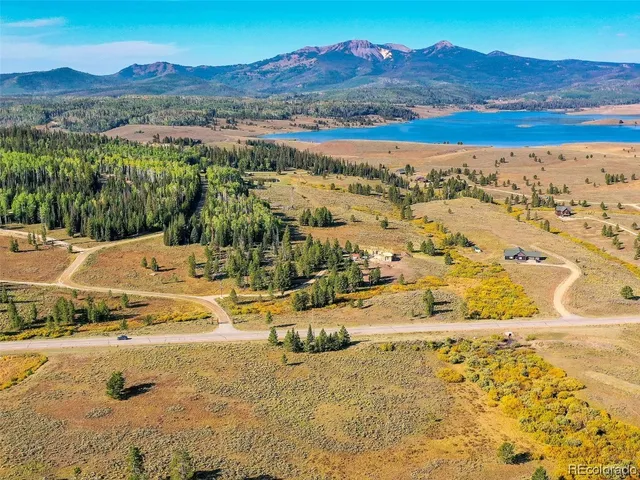 a view of a lake in middle of green field