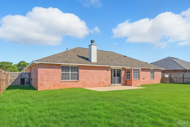 a kitchen with white cabinets and sink