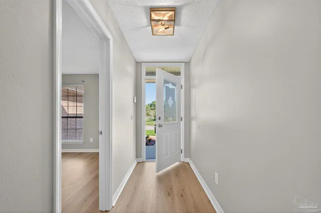 a kitchen with granite countertop a sink stove and refrigerator