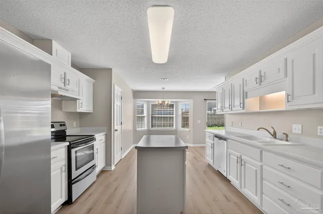 a view of an empty room and wooden floor
