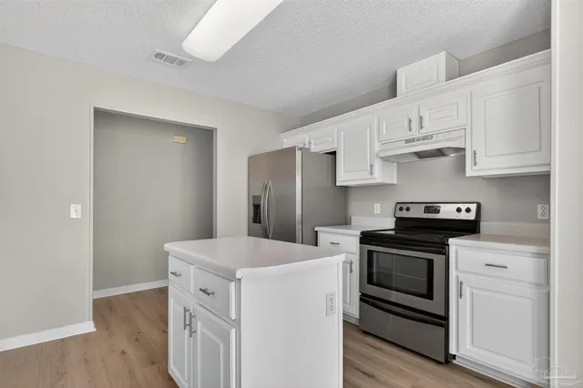 a spacious bathroom with a granite countertop sink mirror and shower
