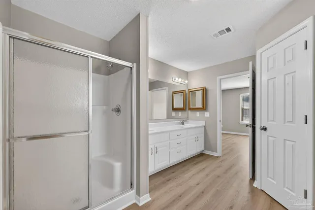 a bathroom with a granite countertop sink a toilet and shower