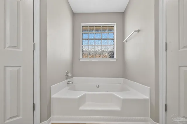 a bathroom with a granite countertop sink a toilet and a mirror