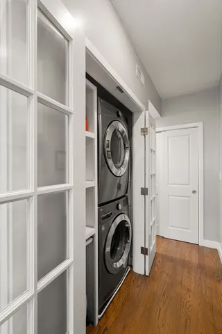 a view of walk in closet with clothes shoes dryer and washer