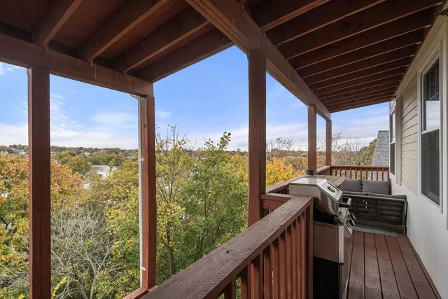a view of a balcony with couches wooden floor and stairs