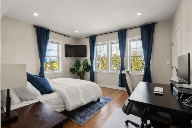 a bedroom with a bed window and a desk
