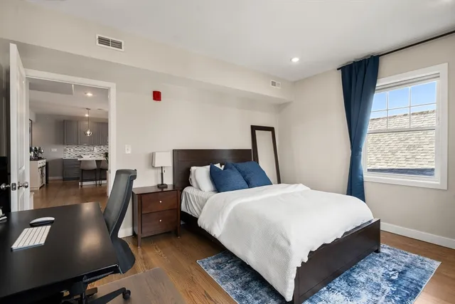 a large bedroom with bed and window