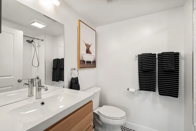 a bathroom with a sink toilet and shower