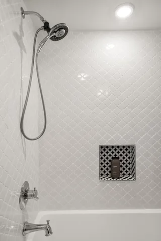 a bathroom with a bathtub and a shower