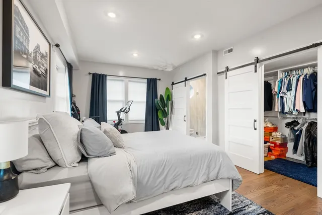 a bedroom with a bed and a walk in closet