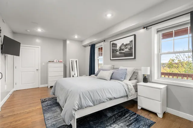 a spacious bedroom with a bed and a large window