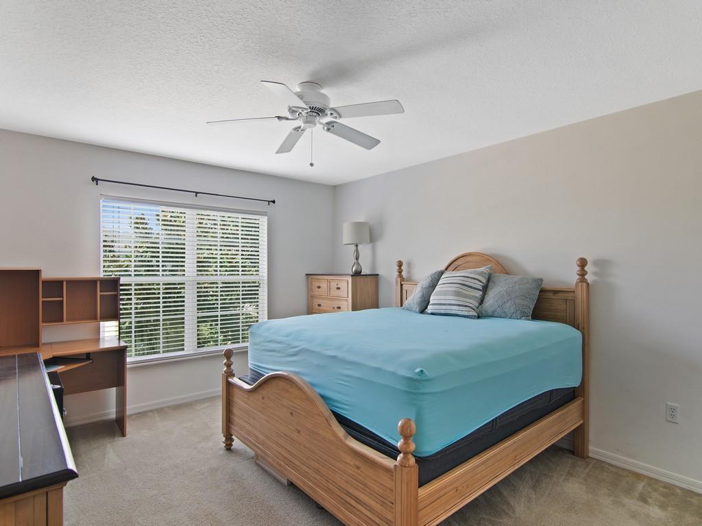 5985 Ridge Lake Circle Vero Beach, FL 32967 - Photo 13 of 27 a bed sitting in a bedroom next to a window