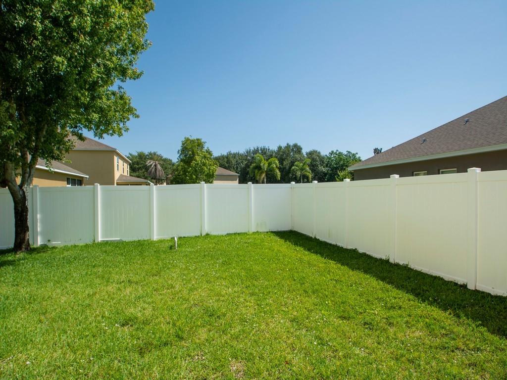 5985 Ridge Lake Circle Vero Beach, FL 32967 - Photo 18 of 27 a view of a yard with a fence