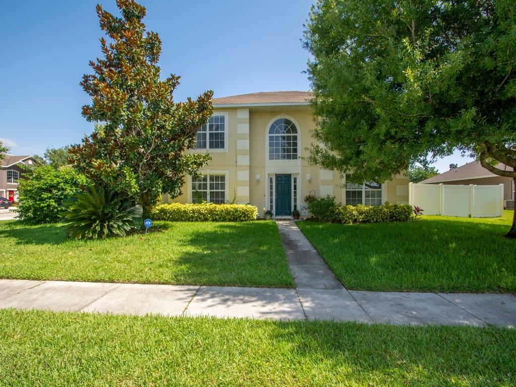 5985 Ridge Lake Circle Vero Beach, FL 32967 - Photo 3 of 27 a front view of a house with a yard