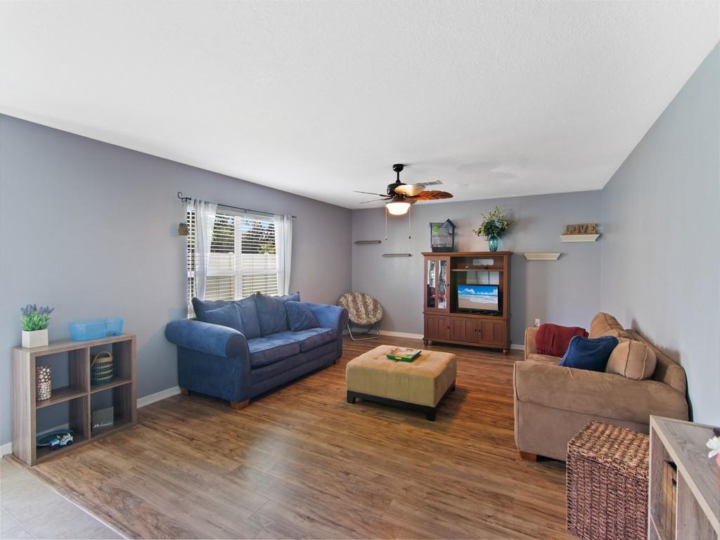5985 Ridge Lake Circle Vero Beach, FL 32967 - Photo 4 of 27 a living room with furniture and a wooden floor